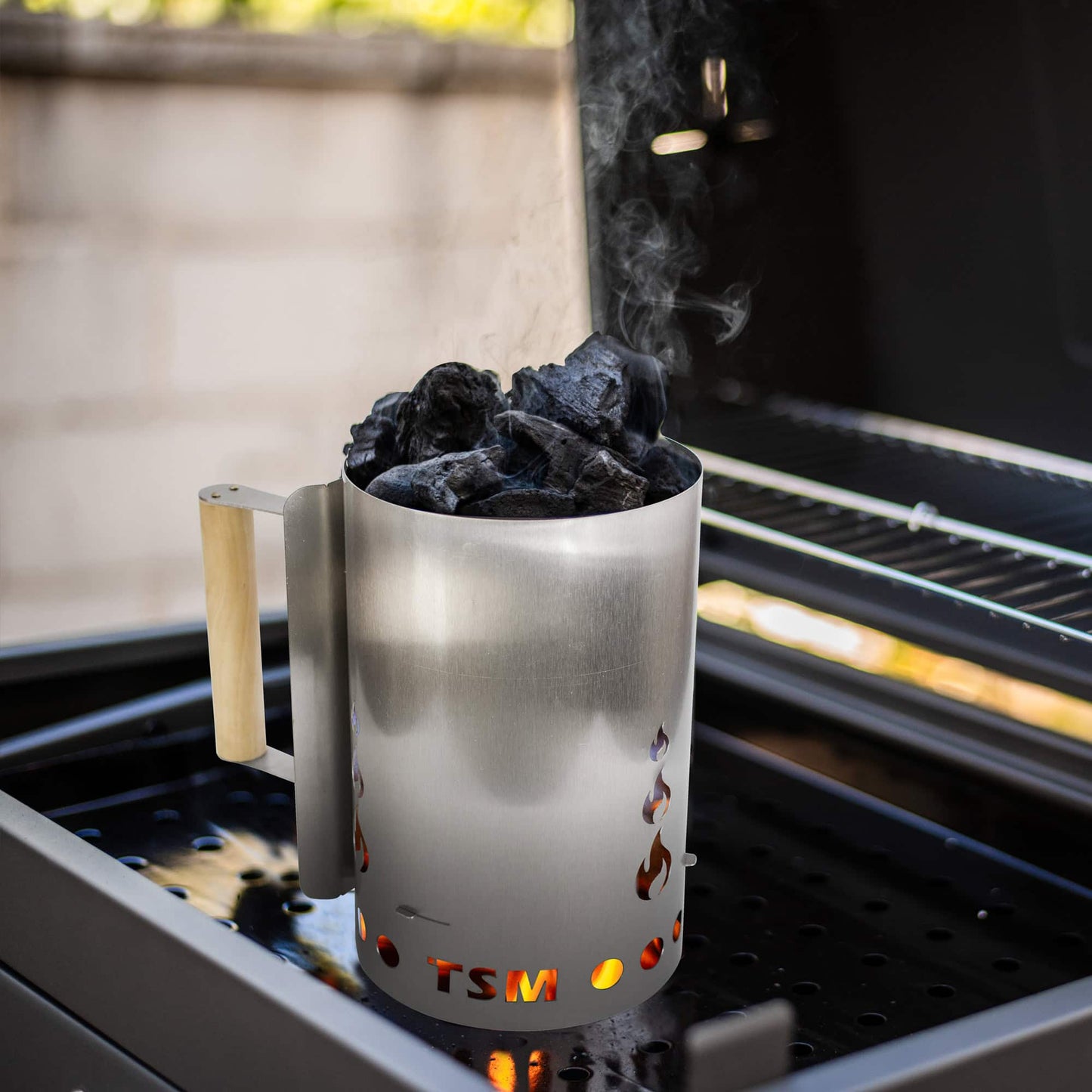 sausage-maker-charcoal-starter-for-grill;firing-up-coal-in-charcoal-starter;inside-view-charcoal-chimney-starter;safe-wooden-handle-of-the-chimney-starter