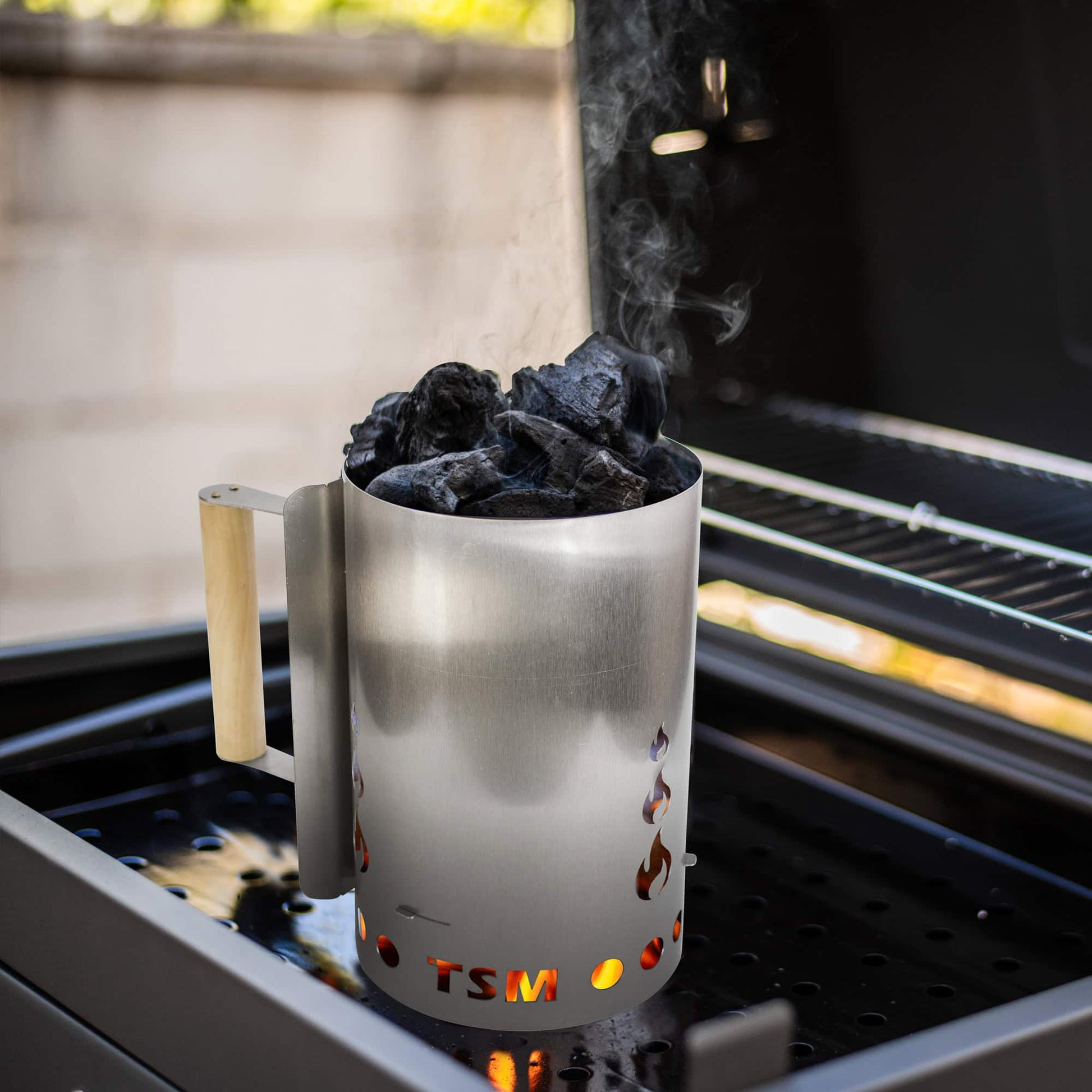 sausage-maker-charcoal-starter-for-grill;firing-up-coal-in-charcoal-starter;inside-view-charcoal-chimney-starter;safe-wooden-handle-of-the-chimney-starter